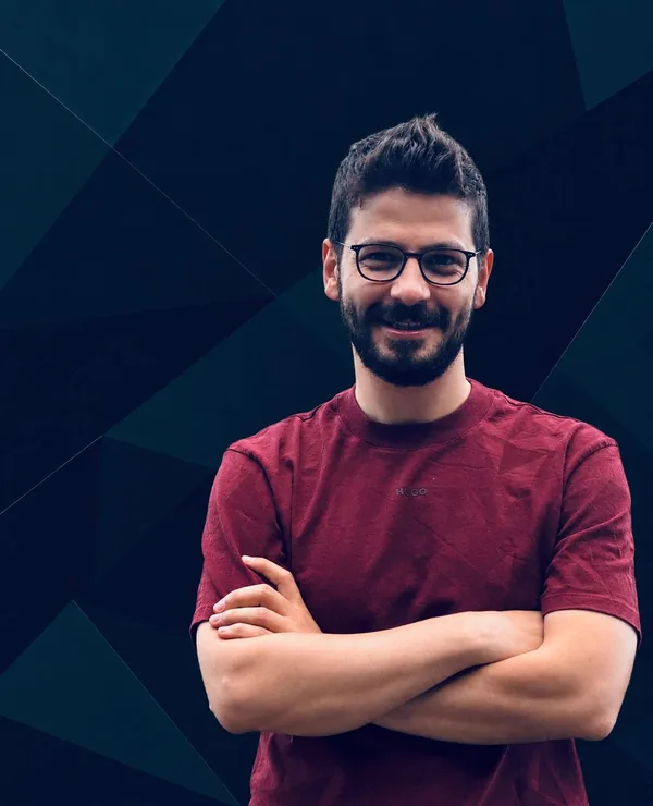 George Yazijy smiling with his arms folded.